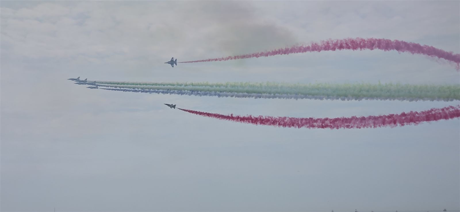 Jets flying in formation with colored smoke trails