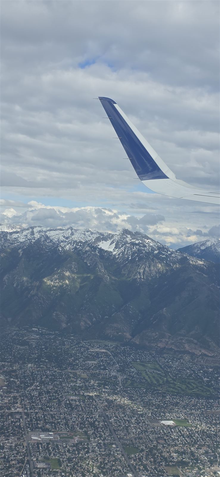 View from a window seat over snow-capped mountains