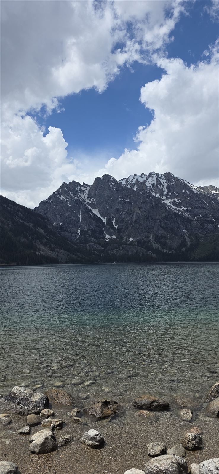 An alpine lake beneath a snow-streaked peak